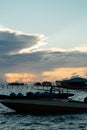 Silhouette of boats and unidentified man working early morning during sunrise. Royalty Free Stock Photo