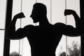Silhouette of bodybuilder in the gym