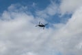 Silhouette of a Boeing V-22 Osprey aircraft on a blue cloudy sky