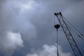 Silhouette of boom high rise crane against background clouds and dramatic sky Royalty Free Stock Photo