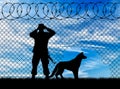 Silhouette of a border guard and a dog