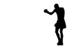 Silhouette. Boxer is right fulfills punches. Slow motion