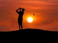 Silhouette the boy golfer playing golf in sunset Royalty Free Stock Photo