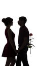 Silhouette of boy holding a gift box with a bow behind her back to congratulate girl, a young couple in love on white isolated Royalty Free Stock Photo