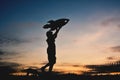 Silhouette boy holding a rocket paper and playing with little dog Royalty Free Stock Photo