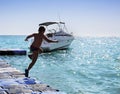 Silhouette of boy jumping into sea Royalty Free Stock Photo