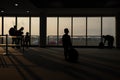 Silhouette boy kid look at airplane taking off from airport departure