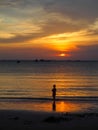 silhouette of boy playing on the beach with sunset Royalty Free Stock Photo