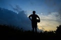 Silhouette of boy playing football during sky sunset background Royalty Free Stock Photo