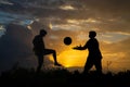Silhouette of boy playing football during sky sunset background Royalty Free Stock Photo
