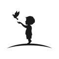 silhouette of boy releasing bird from his hands happily Royalty Free Stock Photo