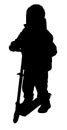 Silhouette of a boy riding scooter Royalty Free Stock Photo