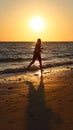 The silhouette of a boy running on the beach