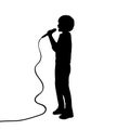 Silhouette boy singing into a microphone Royalty Free Stock Photo