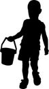 Silhouette of a boy who holds a small bucket in his hand