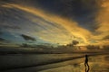 Silhouette boys play on the beach alone