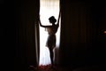 Silhouette of bride girl in the morning in full growth near window in dressing gown on wedding day Royalty Free Stock Photo