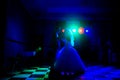 Silhouette of a bride and groom dancing a slow dance in the rest