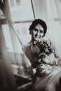 Silhouette of the bride weared in dress and veil with a bouquet