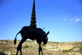 Silhouette of the bronze structure against the view of the arid Murgia of Matera, European Capital of Culture 2019