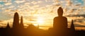 Silhouette of Buddha on golden temple sunset