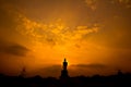 Silhouette Buddha statue in the sunset
