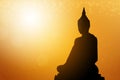 Silhouette buddha statues on blur sunset background. Concept buddha isolated on orange blurred background Royalty Free Stock Photo