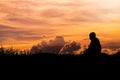 Silhouette - The Buddhist Monk Meditation and clouds evening sky Royalty Free Stock Photo