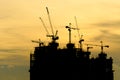 Silhouette Building crane and building under construction against evening Royalty Free Stock Photo