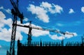 Silhouette building under construction site with blue sky and white clouds