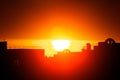 Silhouette of buildings in orange sunset, buildings silhouettes in colourful sunset, evening in the city, flaming red Royalty Free Stock Photo