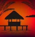 Black silhouette of a bungalow at sunset