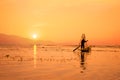 Silhouette of a Burmese fisherman on bamboo boat at sunset. Inle lake, Myanmar Burma, travel destination Royalty Free Stock Photo
