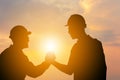 Silhouette of Business engineer man with clipping path handshake evening sky sunset background, Success and happiness team concept