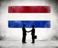 Silhouette of a Business Handshake with a Dutch Flag Royalty Free Stock Photo