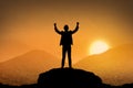 Silhouette business man standing top of the mountain Royalty Free Stock Photo
