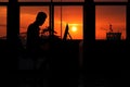 Silhouette business man working on a computer with sunset Royalty Free Stock Photo