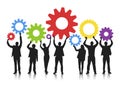 Silhouette of Business People Holding Gears Royalty Free Stock Photo