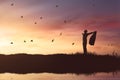 Silhouette of businessman enjoying sun shining with flying birds