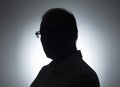 Silhouette of businessman. Male shadow on backlit. Profile of black man in eyeglasses