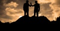 Silhouette businessmen holding hands during sunset Royalty Free Stock Photo