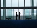 Silhouette Businessmen Shaking Hands At Airport Royalty Free Stock Photo