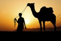 Silhouette of the Camel Trader crossing the sand dune . Royalty Free Stock Photo