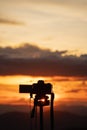 Silhouette of camera mounted on tripod to capture time lapse video of the beautiful colors in the sky during twilight. Royalty Free Stock Photo