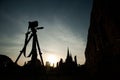 Silhouette of camera on tripod and three pagoda of Wat Phra Sri Sanphet