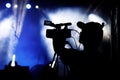 Silhouette of cameraman and camera on a concert. Royalty Free Stock Photo