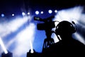 Silhouette of cameraman and camera on a concert. Royalty Free Stock Photo