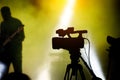 Silhouette of cameraman and camera on a concert. Royalty Free Stock Photo