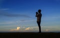 Silhouette cameraman taking photographs in the morning blue hour Royalty Free Stock Photo