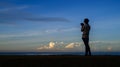 Silhouette cameraman taking photographs in the morning blue hour Royalty Free Stock Photo